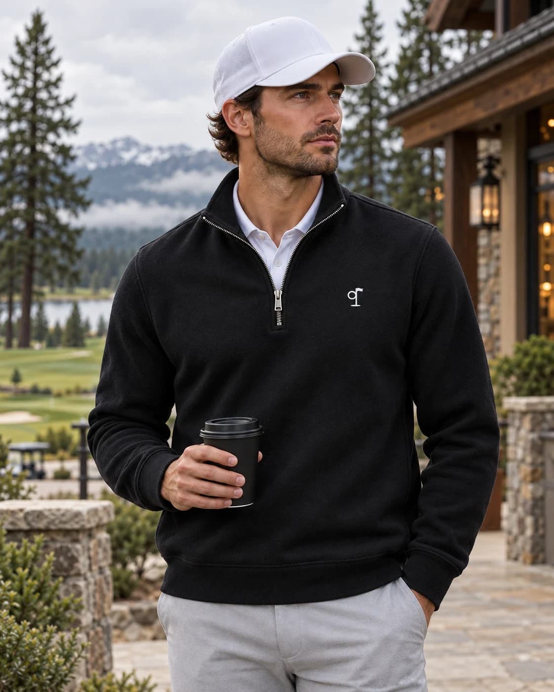 The Pine Half-Zip in black over a white polo outside the clubhouse
